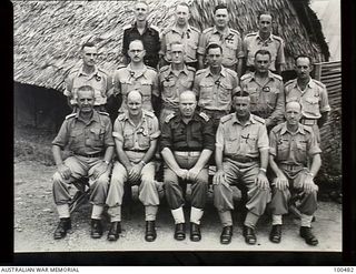 Port Moresby, New Guinea. 1944-05-31. Group portrait of Officers of A Mess, HQ Moresby Base Sub Area. Left to right: Back row: Captain (Capt) R. V. Tiedemann, Capt A. B. Newell; Major (Maj.) D. H. ..