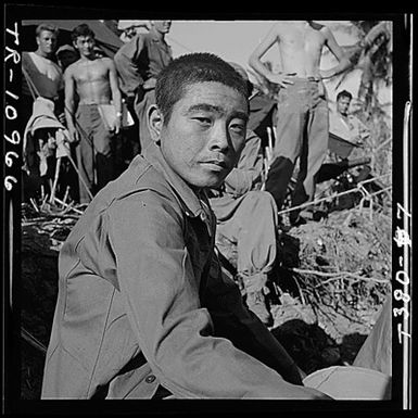 Japanese prisoner awaits questioning by intelligence officer on Guam.