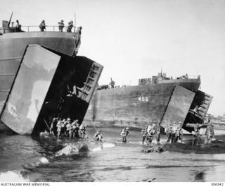 LAE AREA, NEW GUINEA. 1943. AUSTRALIAN TROOPS DISEMBARKING FROM AMERICAN LANDING SHIPS, TANK (LST), INCLUDING LST-456, EAST OF LAE IN PREPARATION FOR THE ASSAULT ON THAT TOWN. 20 MM OERLIKON AA ..