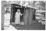 Woman standing outside shed