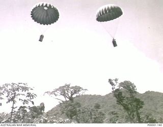 THE SOLOMON ISLANDS, 1945-05. SUPPLIES BEING DROPPED BY PARACHUTE TO AUSTRALIAN TROOPS AT NORTH BOUGAINVILLE. (RNZAF OFFICIAL PHOTOGRAPH.)