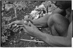 Carving: stone tool being used to smooth an arrow