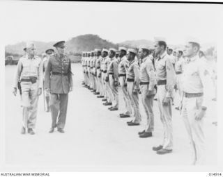 New Guinea. c. 1943. The Australian Governor-General Lord Gowrie inspecting American troops