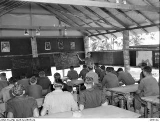 RABAUL, NEW BRITAIN, 1945-12-17. A CLASS IN ARITHMETIC BEING CONDUCTED BY A MEMBER OF THE AUSTRALIAN EDUCATION SERVICE, IN THE EDUCATION CENTRE AT 28 INFANTRY BATTALION