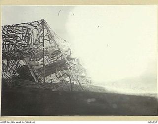 DONADABU AREA, NEW GUINEA. 1943-12-01. A NIGHT FIRING SHOT OF A 25-POUNDER OF THE 2/4TH AUSTRALIAN FIELD REGIMENT