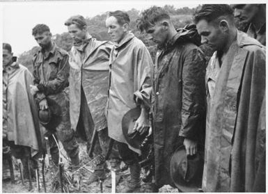 Members of the 2/3rd Australian Independent Company at a burial service. Timbered Knoll, Orodubi, New Guinea, 30 July, 1943