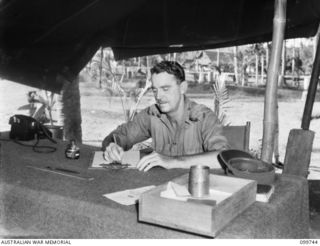 RABAUL, NEW BRITAIN, 1946-02-05. LIEUTENANT-COLONEL J. L. A. KELLY, COMMANDING OFFICER, 31/51ST INFANTRY BATTALION, WRITING HIS FINAL ORDERS OF THE DAY BEFORE HIS DEPARTURE TO HQ, AIF