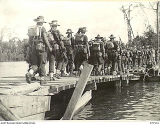 BOUGAINVILLE ISLAND. 1944-12-06. TROOPS OF THE 15TH INFANTRY BATTALION EMBARKING ABOARD A FERRY, DRIVEN BY TWO JEEPS, WHICH CROSSES THE TARGESSI RIVER DURING THEIR ADVANCE TO TAKE OVER THE ..