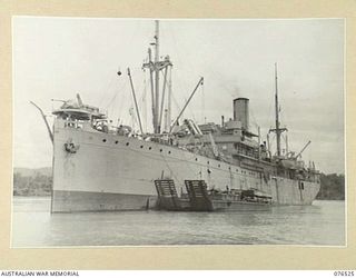 MILFORD HAVEN, LAE, NEW GUINEA. 1944-10-04. THE DUTCH TROOPSHIP "SWARTENHONDT" AT ANCHOR IN THE BAY WHILE LOADING STORES FOR THE 36TH INFANTRY BATTALION