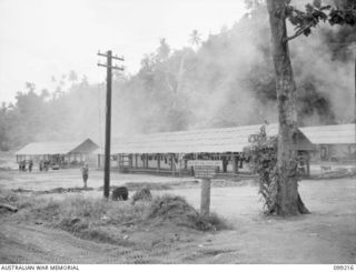 RABAUL, NEW BRITAIN, 1945-11-26. BUILDINGS IN THE CAMP AREA OF 11 DIVISION, SALVAGE UNIT, IN WHICH SALVAGED MATERIAL IS STORED