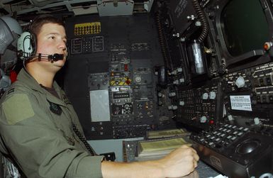 US Air Force (USAF) Captain (CPT) Andy McElyanie, B-52H Stratofortress long range bomber aircraft Deputy Mission Lead and Radar Navigator, 23rd Bomb Squadron (BS), 5th Operations Group (OG), 5th Bomb Wing (BW), Minot Air Force Base (AFB), North Dakota (ND), performs final pre-flight safety checks at his station prior to departing Hickam AFB, Hawaii (HI) to fly back to the Bomber Forward Operating Location (BFOL), operated by the 36th Air Expeditionary Wing (AEW), at Andersen Air Force Base (AFB), Guam (GU), after evacuating Guam because it was threatened by Typhoon Sudal