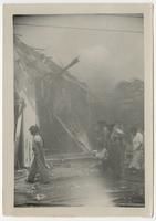 Litter Bearers in Front of Destroyed Motor Torpedo Squadron 3 Warehouse