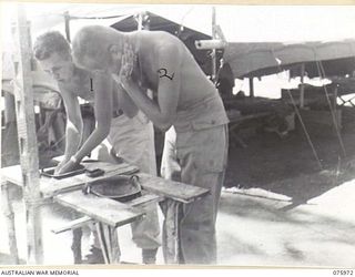 MILILAT, NEW GUINEA. 1944-09-15. PRIVATE C.R. BLANCHARD (1) AND PRIVATE E.A. KLOPKE (2), UNITED STATES ARMY GENERAL HEADQUARTERS DETACHMENT, ATTACHED TO HEADQUARTERS, 5TH DIVISION USING THEIR STEEL ..