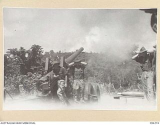 BOIKEN, NEW GUINEA, 1945-07-18. PERSONNEL OF 2/2 FIELD REGIMENT ROYAL AUSTRALIAN ARTILLERY USING A 155MM M1 "LONG TOM" TO FIRE ON A JAPANESE POSITION 14,600 YARDS AWAY