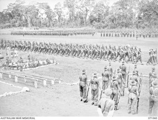 LAE, NEW GUINEA. 1944-03-08. THE PARADE GROUND VIEWED FROM A POINT NEAR THE GRANDSTAND DURING INSPECTION OF THE 29TH INFANTRY BRIGADE BY THE GENERAL OFFICER COMMANDING 2ND AUSTRALIAN CORPS. VX20308 ..