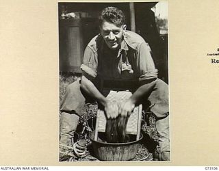 ALEXISHAFEN, NEW GUINEA. 1944-05-09. A SCRUBBING BOARD, ABANDONED BY THE JAPANESE, BEING USED BY VX58009 CORPORAL H. OWEN, 2/15TH FIELD AMBULANCE, A FORMER ORCHARDIST FROM HORSHAM, VICTORIA