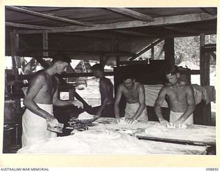 FAURO ISLAND, BOUGAINVILLE AREA. 1945-11-12. PERSONNEL OF 11 FIELD BAKERY, ATTACHED BATTALION HEADQUARTERS, 7 INFANTRY BATTALION, ROLLING AND WEIGHING BREAD. IDENTIFIED PERSONNEL ARE:- PRIVATE C.F. ..