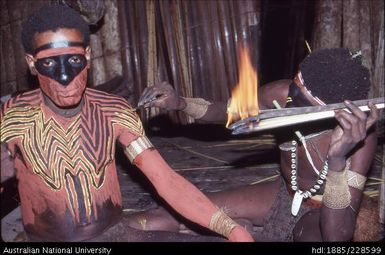 Preparing a dancer for his performance of a curing dance for a sick member of the community