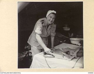 CAPE WOM, WEWAK AREA, NEW GUINEA. 1945-08-02. SISTER R.F. LAWLER, SISTER-IN-CHARGE 104 CASUALTY CLEARING STATION, FINDS A FEW SPARE MOMENTS TO DO HER IRONING