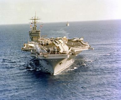 An elevated bow view of the nuclear-powered aircraft carrier USS CARL VINSON (CVN-70) approaching Pearl Harbor. Members of the crew are manning the rail