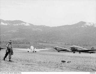 WAU, NEW GUINEA. 1943-08-08. DOUGLAS C47 DAKOTA AIRCRAFT TAKING OFF FROM THE AIRFIELD