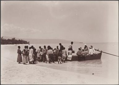 Crowd gathered around passengers in boat departing for the Southern Cross from Rowa, Banks Islands, 1906 / J.W. Beattie