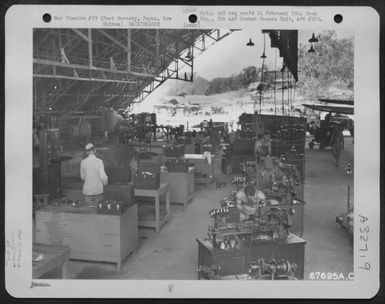 The Machine Shop Of The 27Th Air Depot Group In Located In Hangar #2 At The Port Moresby Air Depot, Papua, New Guinea. This Is An Overall View Of The Men At Work. 1943. (U.S. Air Force Number 67695AC)