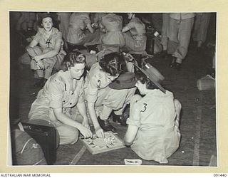 LAE, NEW GUINEA, 1945-05-07. AUSTRALIAN WOMEN'S ARMY SERVICE PLAYING CHINESE CHECKERS WHILE WAITING TO DISEMBARK FROM THE MV DUNTROON. THEY ARE PART OF A GROUP OF 342 AUSTRALIAN WOMEN'S ARMY ..