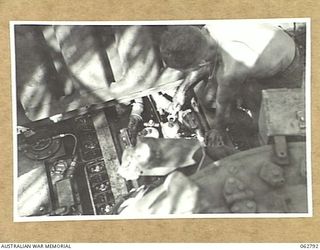 HUON PENINSULA AREA, NEW GUINEA. 1944-01-08. NX139417 CRAFTSMAN W. G. HOBBS (1) OF THE 209TH LIGHT AID DETACHMENT TUNING THE ENGINE OF A MATILDA TANK AT THE UNIT WORKSHOP ON THE BANK OF THE SANGA ..