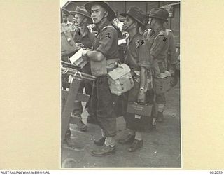 CAIRNS, QLD. 1944-10-30. OFFICERS OF HQ 6 DIV BOARDING THE SHIP DURING EMBARKATION TO NEW GUINEA WITH ELEMENTS OF 6 DIVISION IDENTIFIED PERSONNEL ARE:- CAPT A.C. PEPPER (1); CAPT T.V. WALPOLE, ..