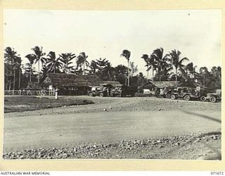 LAE, NEW GUINEA. 1944-03-24. ADMINISTRATION BUILDINGS AT HEADQUARTERS LAE BASE SUB-AREA SHOWING THE CAMP COMMANDANT'S OFFICE, POST OFFICE, MEDICAL BRANCH AND THE CAR PARK. (JOINS WITH PHOTOGRAPHS ..