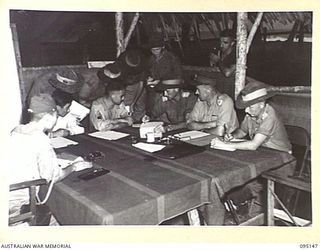 TOKO, BOUGAINVILLE, 1945-08-18. A GENERAL VIEW OF THE INTERROGATION OF MAJOR OTSU, MEMBER OF A SURRENDER ENVOY FROM LIEUTENANT-GENERAL M. KANDA, COMMANDER IMPERIAL JAPANESE 17 ARMY GROUP, DURING AN ..