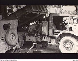 REINHOLD HIGHWAY, NEW GUINEA, 1943-09-03. ENGINEERS OF THE 2/55TH AUSTRALIAN LIGHT AID DETACHMENT WORKING ON A TIPPING TRUCK AT THE 7 MILE WORKSHOP