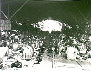 THE SOLOMON ISLANDS, 1945-10-18. JAPANESE SERVICE PERSONNEL IN ONE OF THE LIVING HUTS AT THEIR INTERNMENT CAMP AT TOROKINA, BOUGAINVILLE ISLAND. (RNZAF OFFICIAL PHOTOGRAPH.)