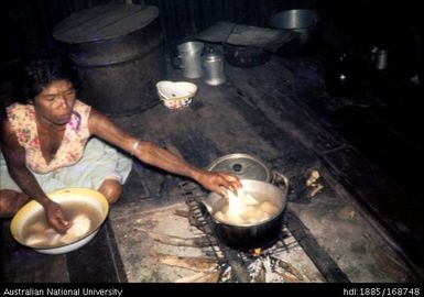 Putting yams on to cook - house interior, Kaporaka