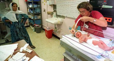 The first Kurdish evacuee to become an American due to her birth on US soil at Naval Hospital Guam is measured by US Navy Lieutenant Joyce Siler as the infant's grandmother keeps an eye on the procedure. The 8 lb. 13 oz. girl was named Helan, which means "leaving" in arabic. Helan will avoid the immigration processing required for the other Kurdish evacuees of Operation PACIFIC HAVEN currently being housed at Andersen Air Force Base, Guam. The operation, a joint humanitarian effort conducted by the US military, entails the evacuation of approximately 2,400 Kurds from northern Iraq to avoid retaliation from Iraq for working with the US government and international humanitarian agencies...