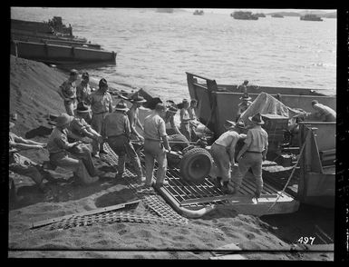 New Zealand soldiers loading equipment into landing craft before leaving New Caledonia for the north, during World War II