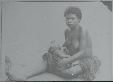 A mother feeding her baby (given to us by Professor Sir Edward Ford from his 1938 collection) : Environs of Mapamoiwa, D'Entrecasteaux Islands, Papua New Guinea, 1956 / Terence and Margaret Spencer