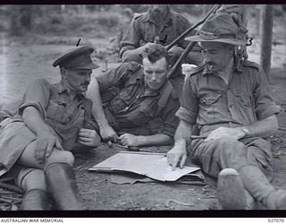 PAPUA, NEW GUINEA. 1942-10. PLANNING THE CAMPAIGN MOVES FROM THE ADVANCED HEADQUARTERS AT NAURO IN THE OWEN STANLEY RANGES. LEFT TO RIGHT:- LIEUTENANT-COLONEL S.J. BLEECHMORE, COMMANDING ROYAL ..