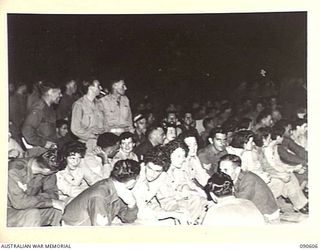 TOROKINA, BOUGAINVILLE. 1945-04-12/13. PORTION OF THE AUDIENCE AT INTERVAL DURING A CONCERT PRODUCED BY 7 FIELD AMBULANCE TROOPS FOR THE ENTERTAINMENT OF UNIT PERSONNEL, PATIENTS AND NEARBY UNITS ..