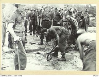LAE, NEW GUINEA. 1944-08-09. TROOPS OF THE 20TH FIELD COMPANY, DIGGING THE FOUNDATIONS FOR A NEW BRIDGE TO REPLACE THE ONE WHICH WAS WASHED AWAY DURING THE RECENT HEAVY FLOODS. IDENTIFIED PERSONNEL ..