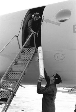 Members of Naval Air Reserve Patrol Squadron 64 (VP-64) load an SSQ-77 sonobuoy into a P-3 Orion aircraft during active duty training