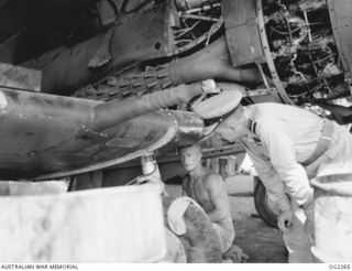 TOROKINA, BOUGAINVILLE ISLAND, SOLOMON ISLANDS. 1945-02-18. CHIEF OF AIR STAFF AIR VICE-MARSHAL JONES CB CBE DFC (RIGHT) QUESTIONS RAAF FITTER 22111 CORPORAL R. H. BALL OF BRISBANE, QLD, WHILE HE ..