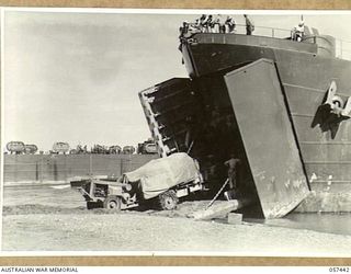 FINSCHHAFEN, NEW GUINEA, 1943-09-22. LOADING THE FINSCHHAFEN FORCE EQUIPMENT INTO AN LST (LANDING SHIP, TANK)