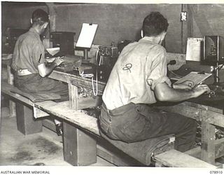 LAE, NEW GUINEA. 1945-02-06. VX66060 CORPORAL R. LINDSAY (1) AND NX151177 SIGNALLER W.E. BALL (2) OPERATING WHEATSTONE EQUIPMENT AT THE SIGNALS TRANSMITTING CENTRE OF THE 19TH LINES OF ..