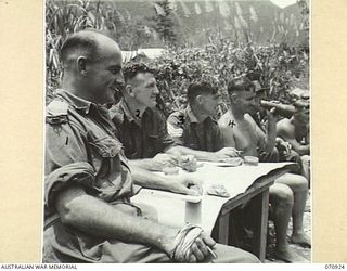 ZENAG, NEW GUINEA, 1944-02-27. OFFICIALS WATCHING CONTESTS AT A SPORTS CARNIVAL HELD IN A CREEK DAMMED BY MEMBERS OF THE 2/9TH FIELD COMPANY, ROYAL AUSTRALIAN ENGINEERS. ATTENDED BY VISITORS FROM ..
