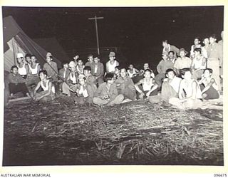 LAE, NEW GUINEA. 1945-09-09. SOME OF THE FORMOSANS IN THE AUDIENCE WATCHING A PERFORMANCE BY A FORMOSAN CONCERT PARTY IN A PRISONER OF WAR CAMP