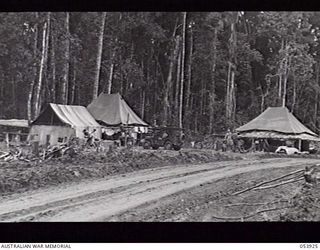 REINHOLD HIGHWAY, NEW GUINEA. 1943-07-08. STAFF LINES OF THE 46TH AUSTRALIAN CAMP HOSPITAL. MEN WORKING IN FOREGROUND