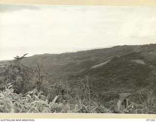 FINSCHHAFEN AREA, NEW GUINEA. 1944-03-18. ONE OF THREE PHOTOGRAPHS FORMING A PANORAMA OF SATTELBERG VIEWED FROM KUANKO. (JOINS WITH NOS. 71261 AND 71260)