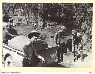 JAPANESE SOLDIERS WATCHED BY A MEMBER OF 11 DIVISION SIGNALS, CARRY OUT WORKING DUTIES FOR THE UNIT